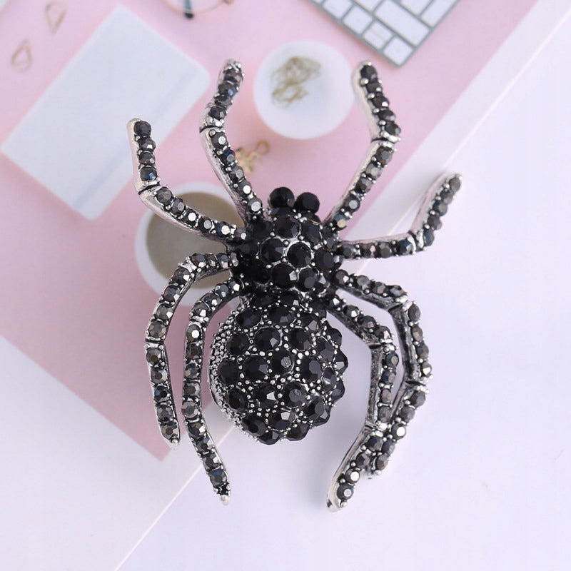 Schwarze Spinnenbrosche mit Zirkonia