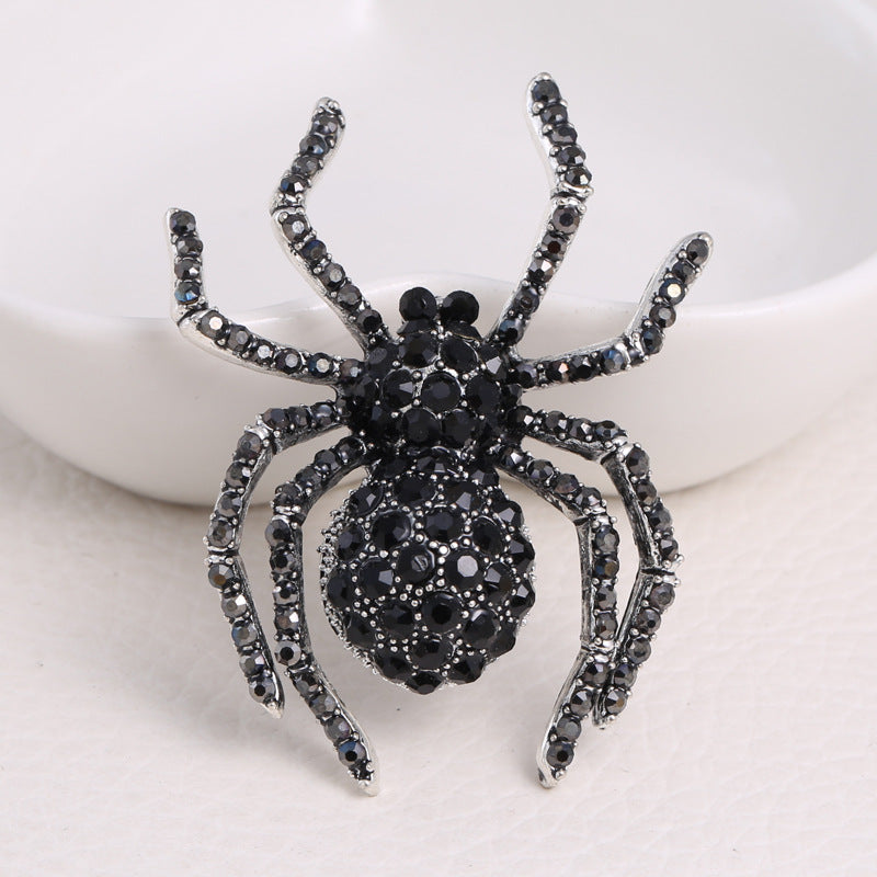 Schwarze Spinnenbrosche mit Zirkonia